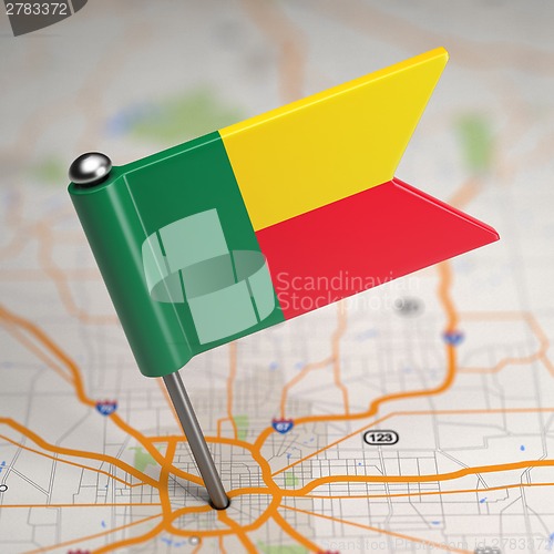 Image of Benin Small Flag on a Map Background.