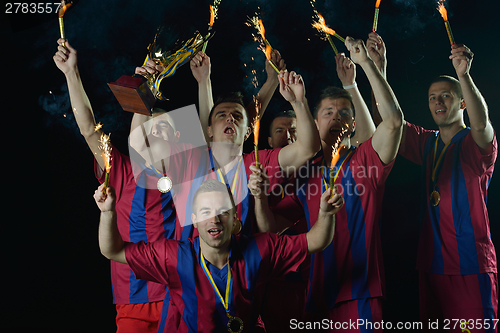 Image of soccer players celebrating victory