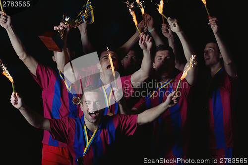 Image of soccer players celebrating victory