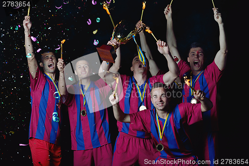 Image of soccer players celebrating victory