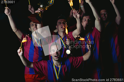 Image of soccer players celebrating victory