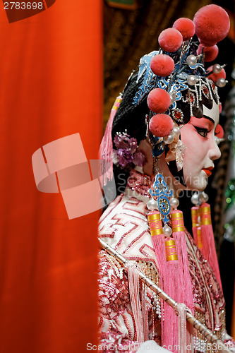 Image of chinese opera dummy and red cloth as text space ,it is a toy,not