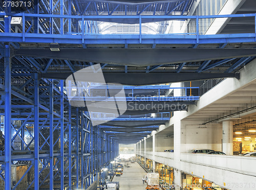 Image of Rows of shelves with boxes in factory warehouse 