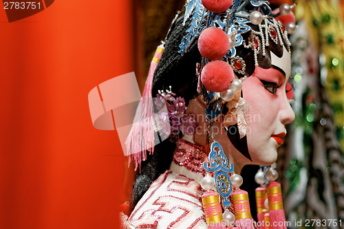 Image of chinese opera dummy and red cloth as text space ,it is a toy,not