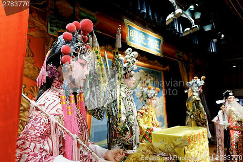 Image of chinese opera dummy and red cloth as text space ,it is a toy,not