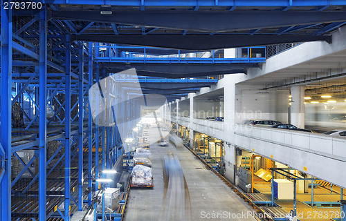 Image of Rows of shelves with boxes in factory warehouse 