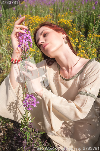 Image of Beautiful red-hair girl on meadow