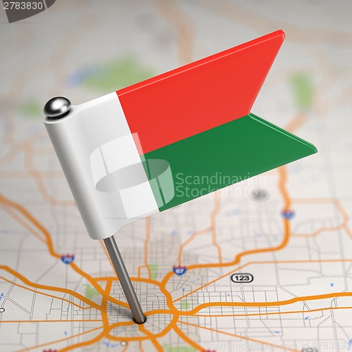 Image of Madagascar Small Flag on a Map Background.