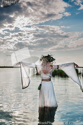 Image of Beautiful woman with flower wreath in watet