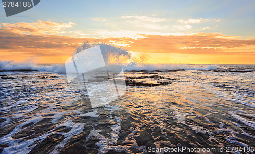 Image of Sunrise seascape splash in the shape of a wave