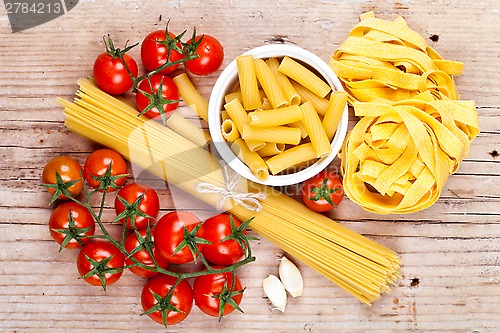 Image of uncooked pasta with tomatoes