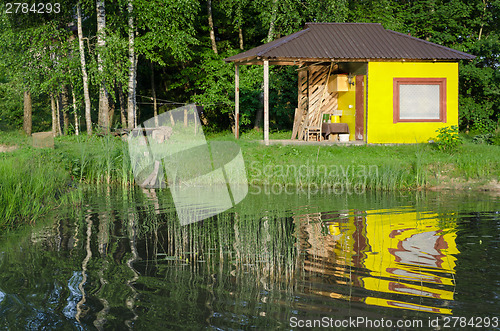Image of relaxation bathhouse at country pond summer time 