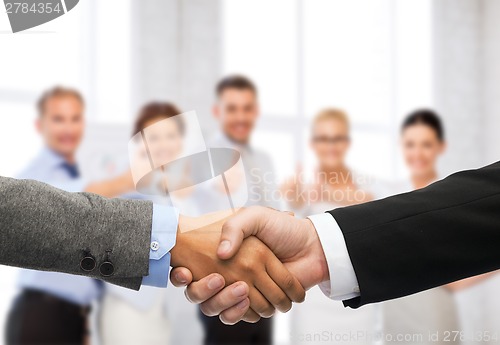 Image of businessman and businesswoman shaking hands