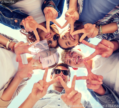 Image of group of teenagers showing finger five