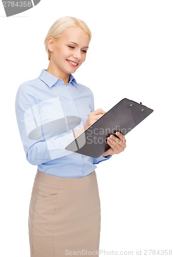 Image of smiling businesswoman with clipboard and pen