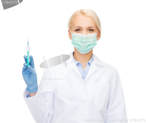 Image of doctor in mask holding syringe with injection