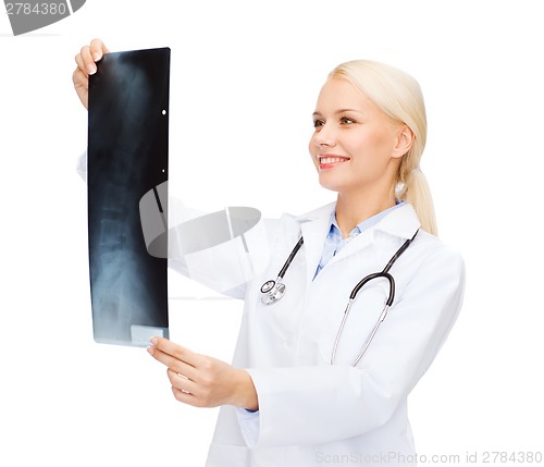 Image of smiling female doctor looking at x-ray