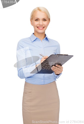 Image of smiling businesswoman with clipboard and pen