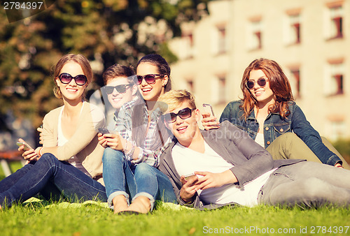 Image of students looking at smartphones and tablet pc