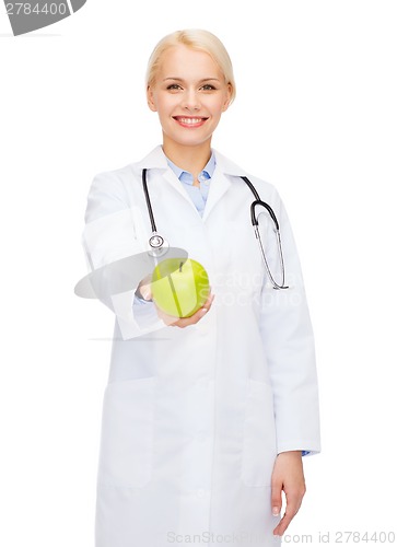 Image of smiling female doctor with green apple