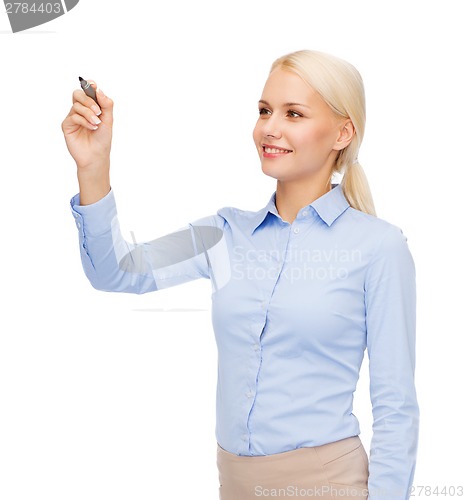 Image of businesswoman writing something in air with marker