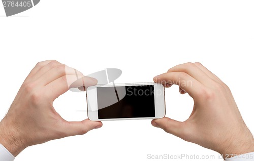 Image of close up of man hands holding smartphone