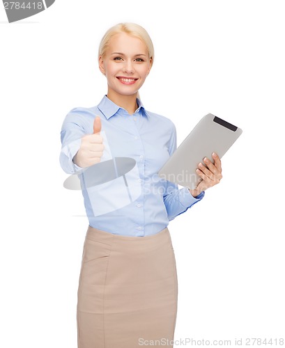 Image of smiling woman looking at tablet pc computer