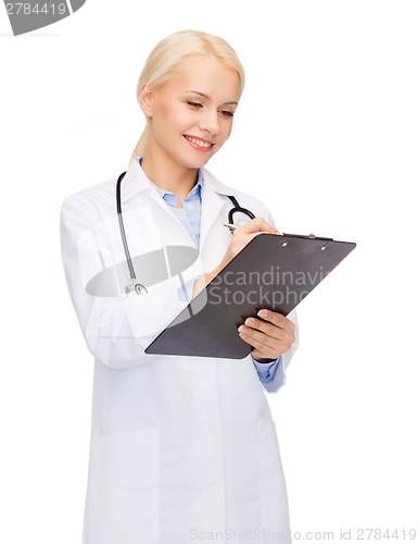 Image of smiling female doctor with clipboard