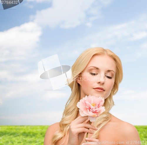 Image of lovely woman with peony flower