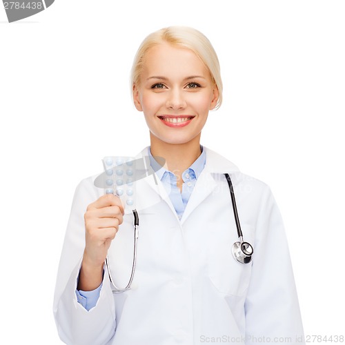 Image of smiling female doctor with pills