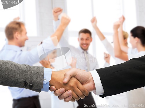 Image of businessman and businesswoman shaking hands