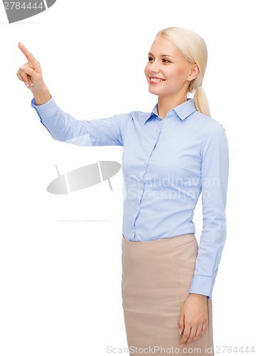 Image of smiling businesswoman working with virtual screen