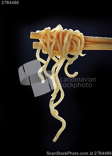 Image of Chopsticks with noodles