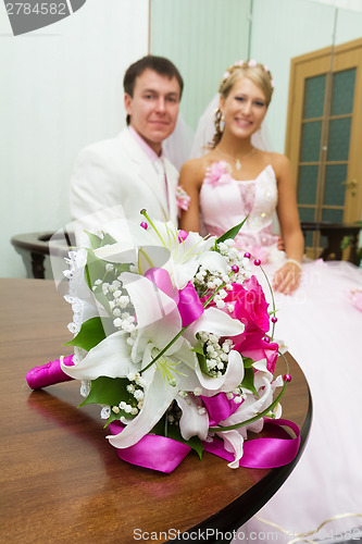 Image of wedding. Bridal bouquet on background of happy newlyweds