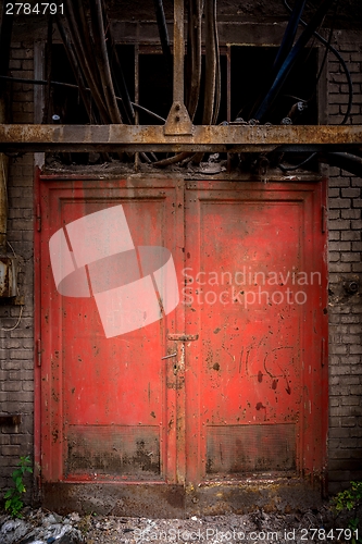 Image of Gray steel wall with the red door