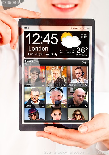 Image of Tablet with transparent screen in human hands.