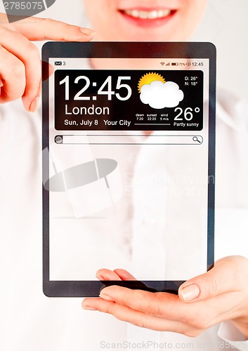 Image of Tablet with transparent screen in human hands.