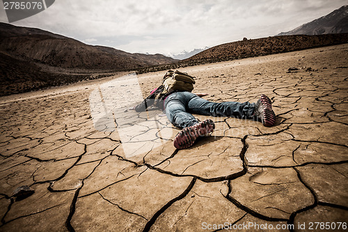 Image of person lays on the dried ground