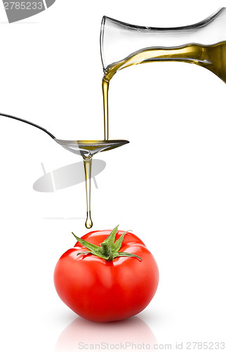 Image of red tomato and pouring oil isolated on white