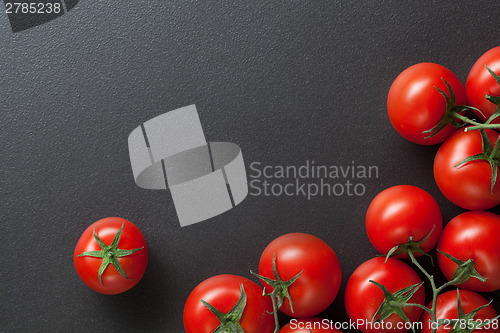 Image of red tomatoes on black. top view