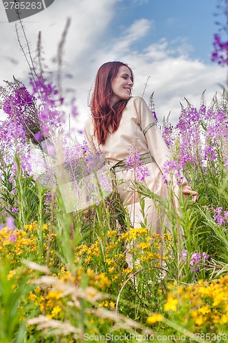 Image of Beautiful red-hair girl relaxing on meadow