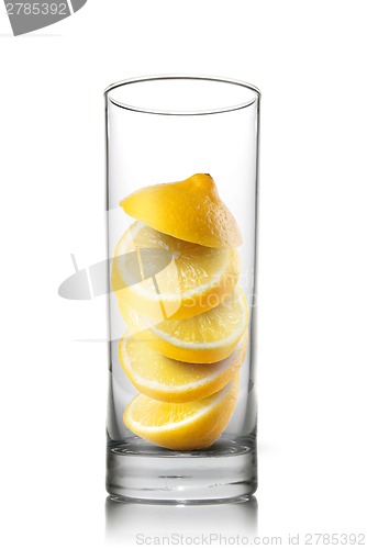 Image of falling lemon slices inside glass isolated