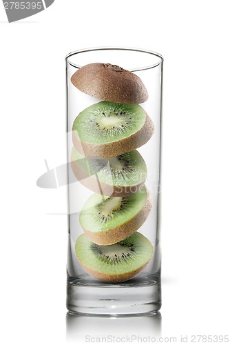 Image of falling kiwi slices inside glass isolated