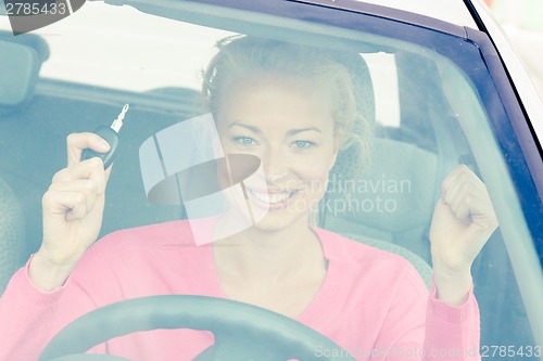 Image of Woman driver showing car keys.