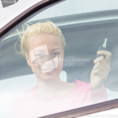 Image of Woman driver showing car keys.