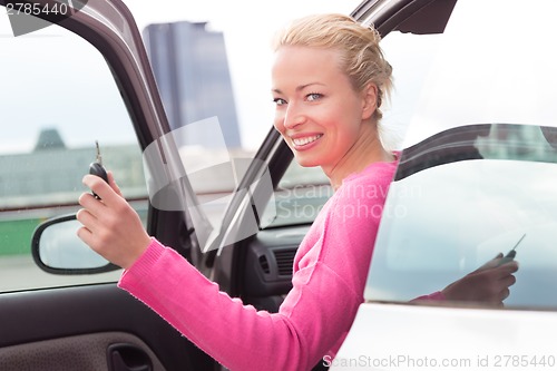 Image of Woman driver showing car keys.