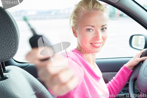 Image of Woman driver showing car keys.