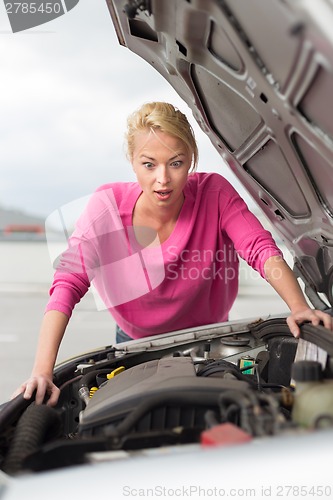 Image of Stressed Young Woman with Car Defect.