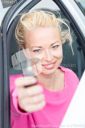 Image of Woman driver showing car keys.