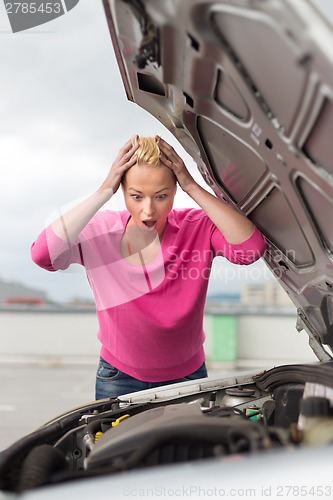 Image of Stressed Young Woman with Car Defect.